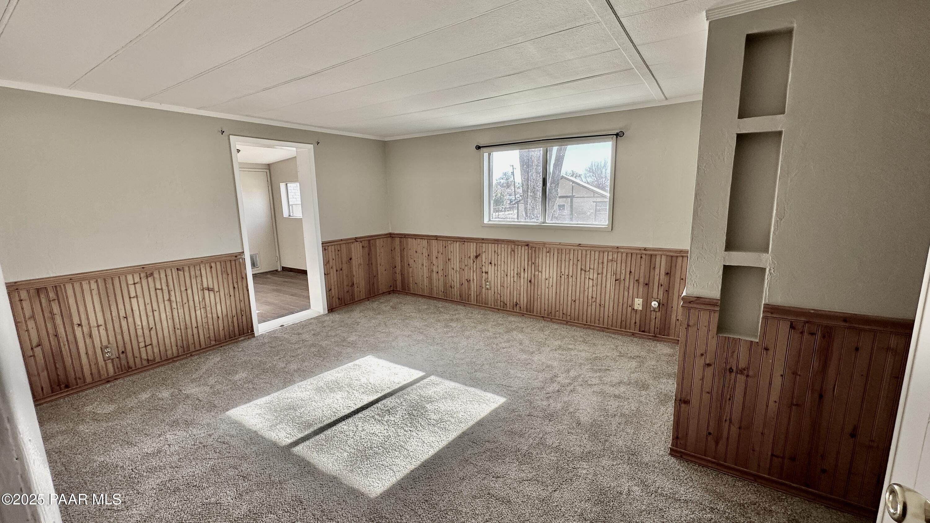 1331 East Red Cinder Road Chino Valley, AZ 86323 - Photo 23 of 58 a view of an empty room with wooden floor and a window