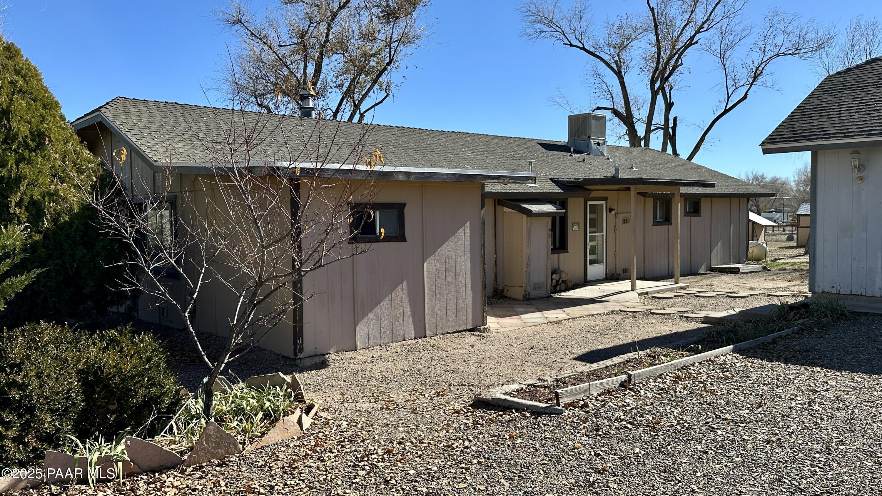 1331 East Red Cinder Road Chino Valley, AZ 86323 - Photo 3 of 58 a view of a white house with a large tree