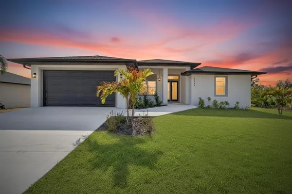 a view of a patio with lawn chairs floor to ceiling window and an outdoor space