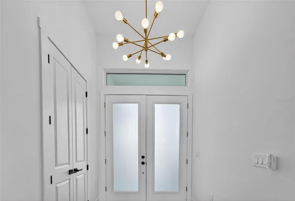 a view of a room with wooden floor and window