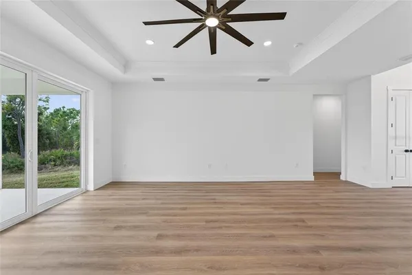 a large kitchen with cabinets wooden floor and stainless steel appliances