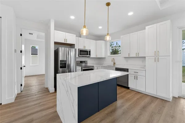 a view of walk in closet with clothes shoes and a washer