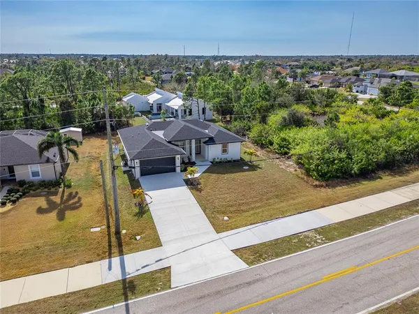 an aerial view of a residential houses with outdoor space