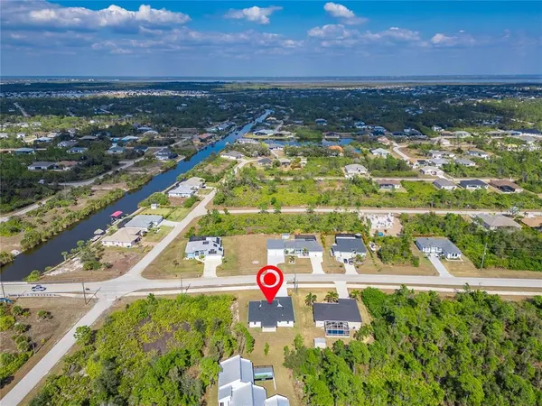 an aerial view of a residential houses with outdoor space