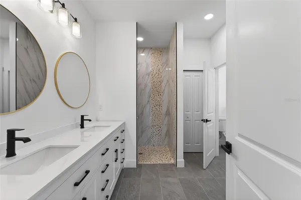 an empty room with window and hardwood floor