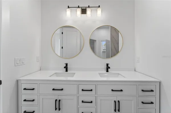 a bathroom with a toilet a sink and a mirror