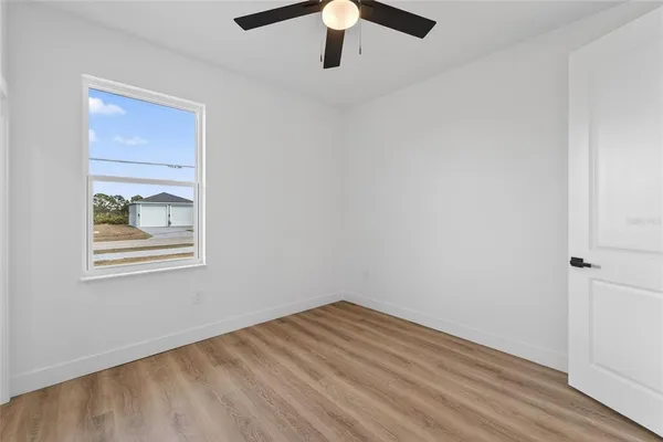 a view of a hallway with a ceiling fan