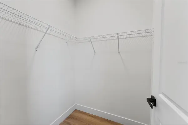 a very nice looking room with a large window and ceiling fan