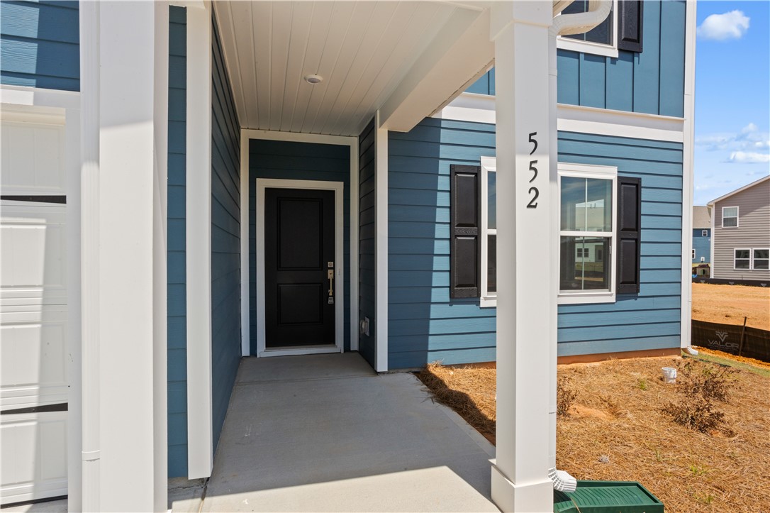 552 Hydrangea Street, Unit LOT 66 Seneca, SC 29678 - Photo 3 of 31 A welcoming covered entry invites you into this charming residence with blue siding.