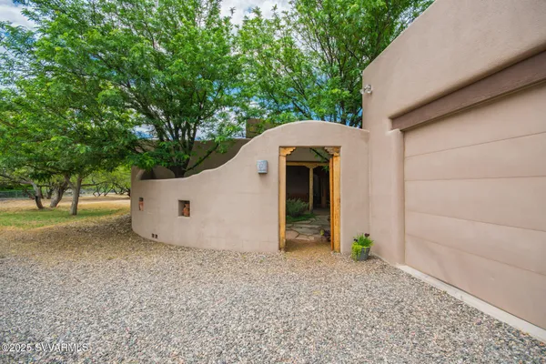 a view of a small space in front of a house with a trees