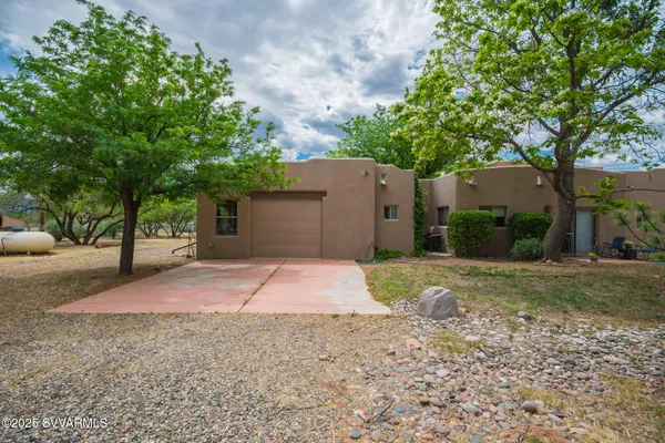 a view of a yard with a tree