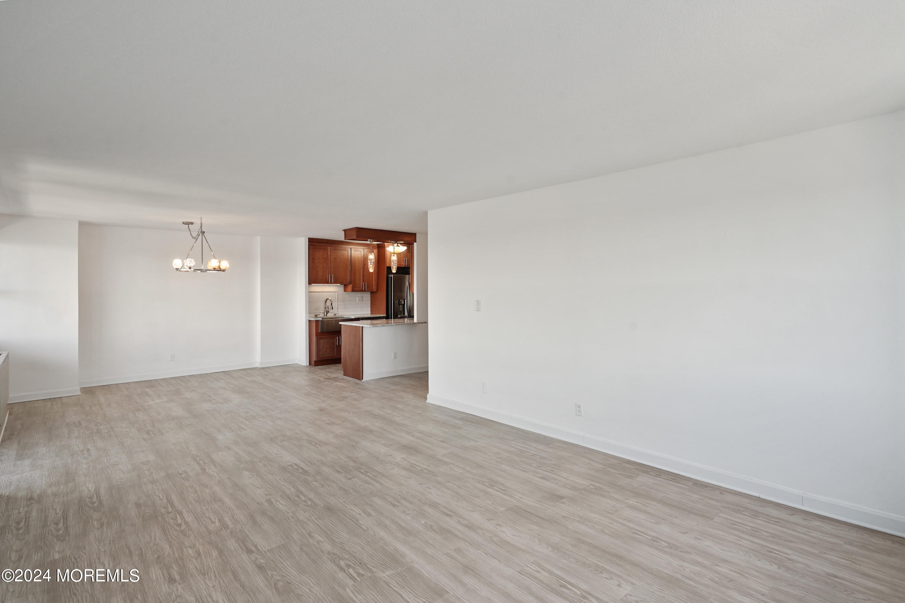 28 Riverside Avenue, Unit 8N Red Bank, NJ 07701 - Photo 11 of 30 a view of empty room with wooden floor