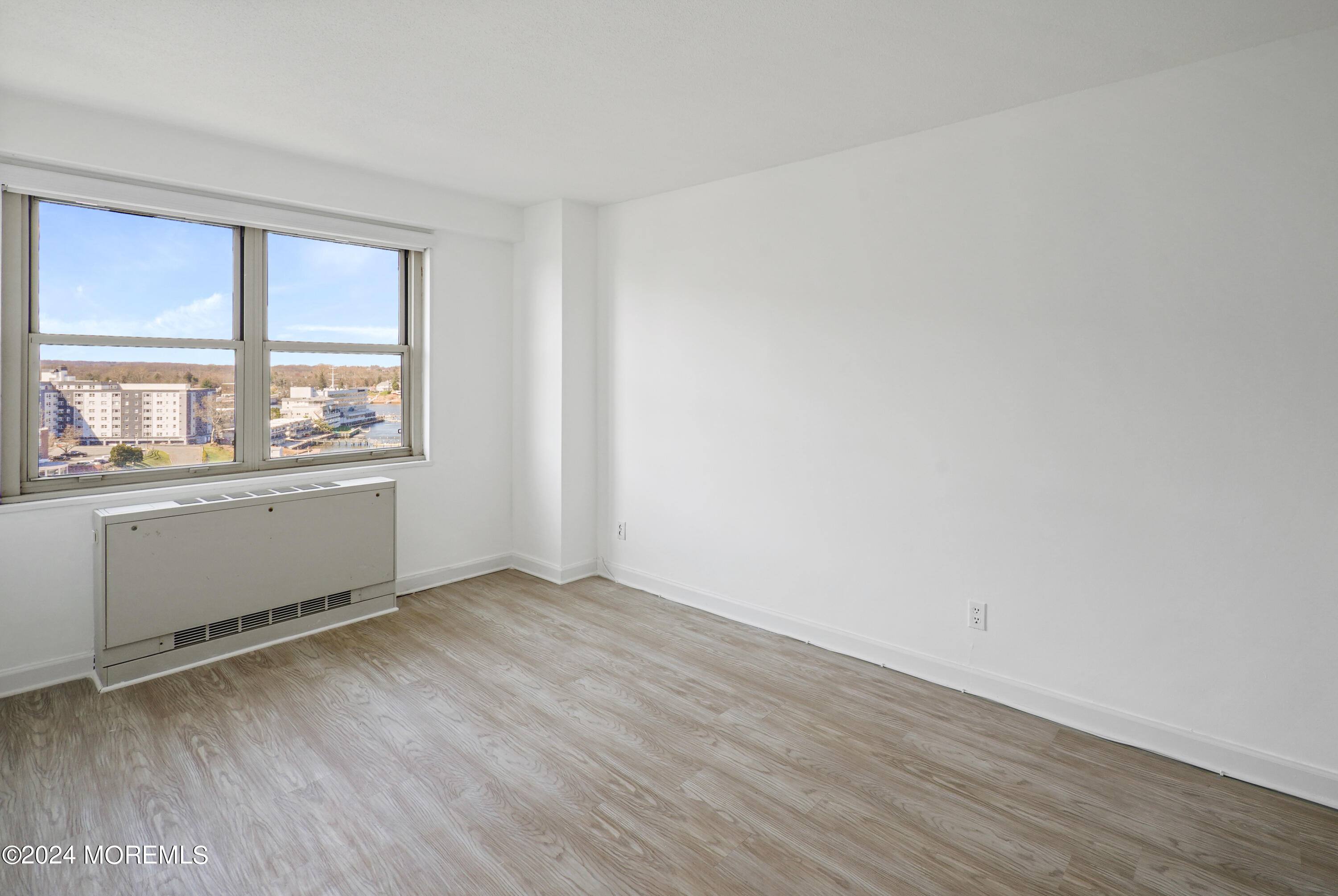 28 Riverside Avenue, Unit 8N Red Bank, NJ 07701 - Photo 13 of 30 an empty room with wooden floor and windows