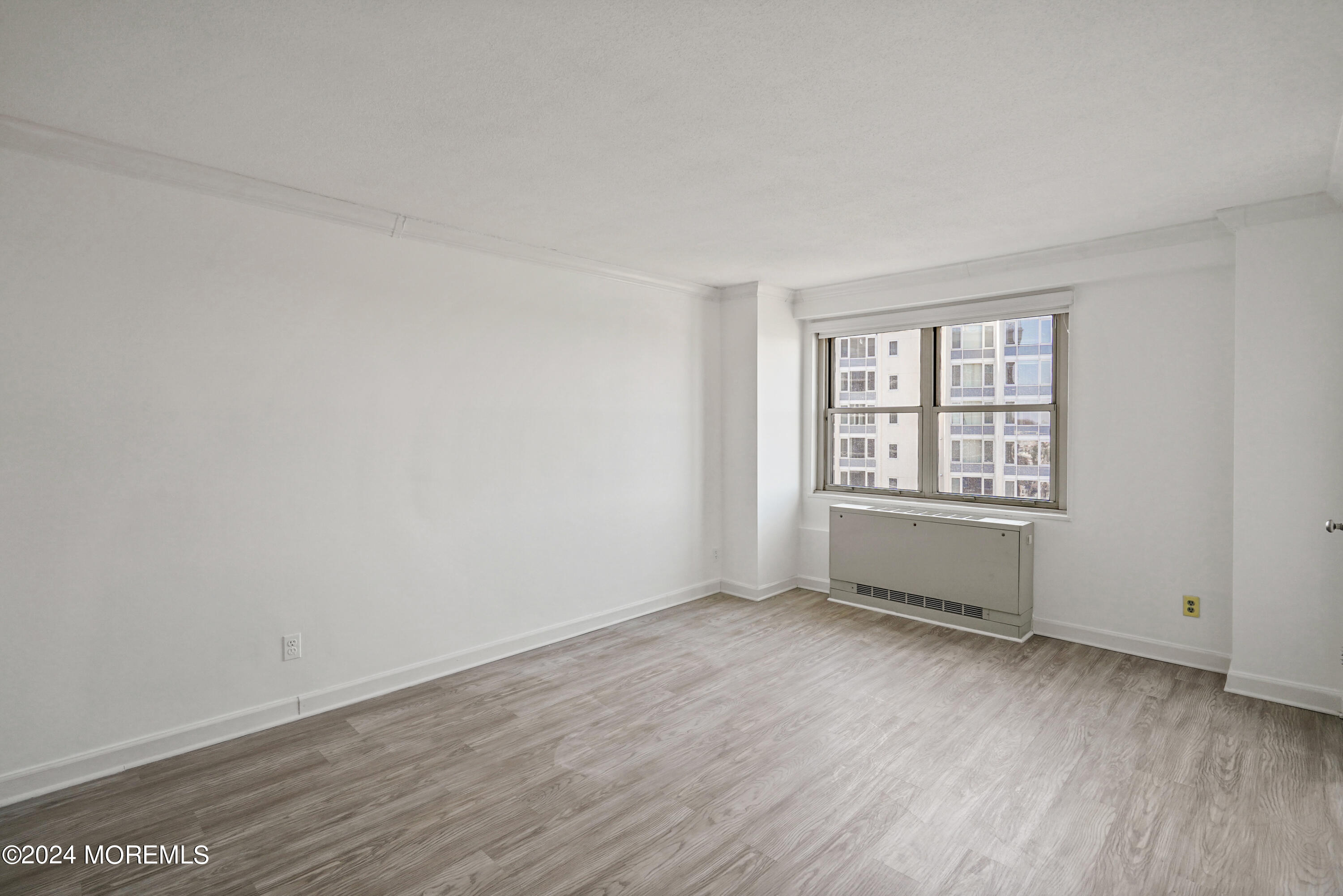 28 Riverside Avenue, Unit 8N Red Bank, NJ 07701 - Photo 16 of 30 an empty room with wooden floor and windows