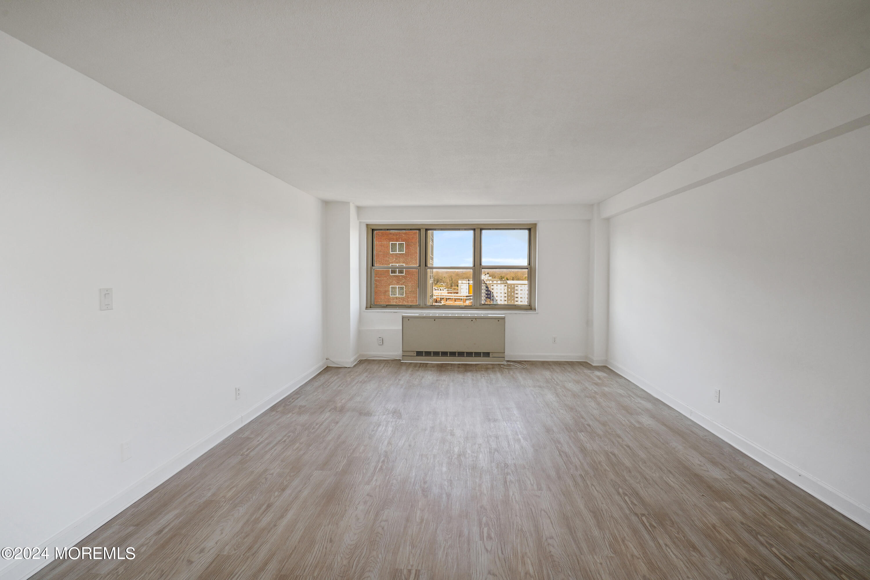 28 Riverside Avenue, Unit 8N Red Bank, NJ 07701 - Photo 17 of 30 an empty room with wooden floor and windows