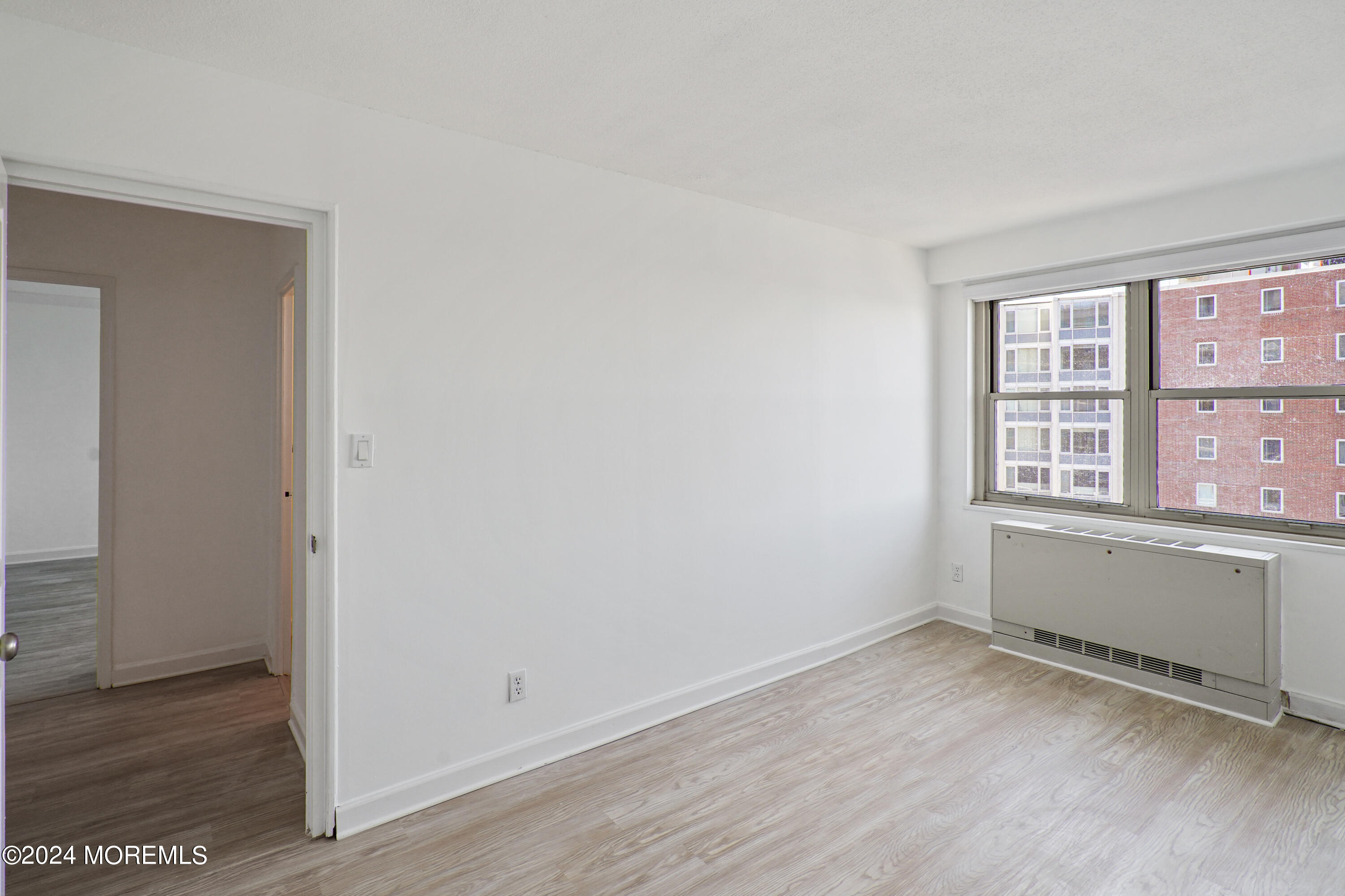 28 Riverside Avenue, Unit 8N Red Bank, NJ 07701 - Photo 18 of 30 an empty room with wooden floor and windows