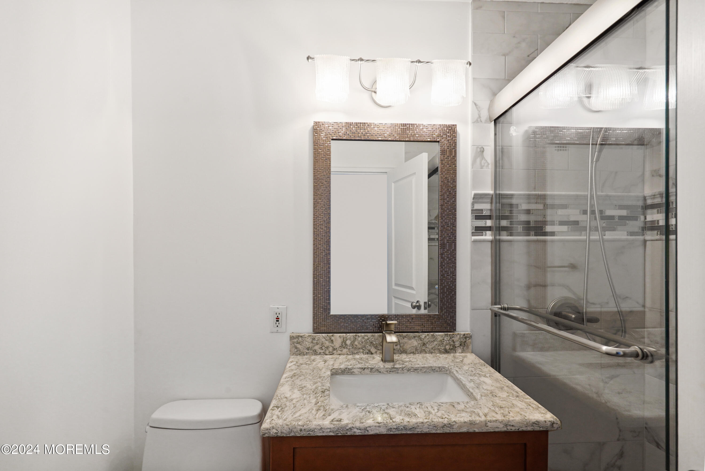 28 Riverside Avenue, Unit 8N Red Bank, NJ 07701 - Photo 19 of 30 a bathroom with a granite countertop sink a toilet and a mirror