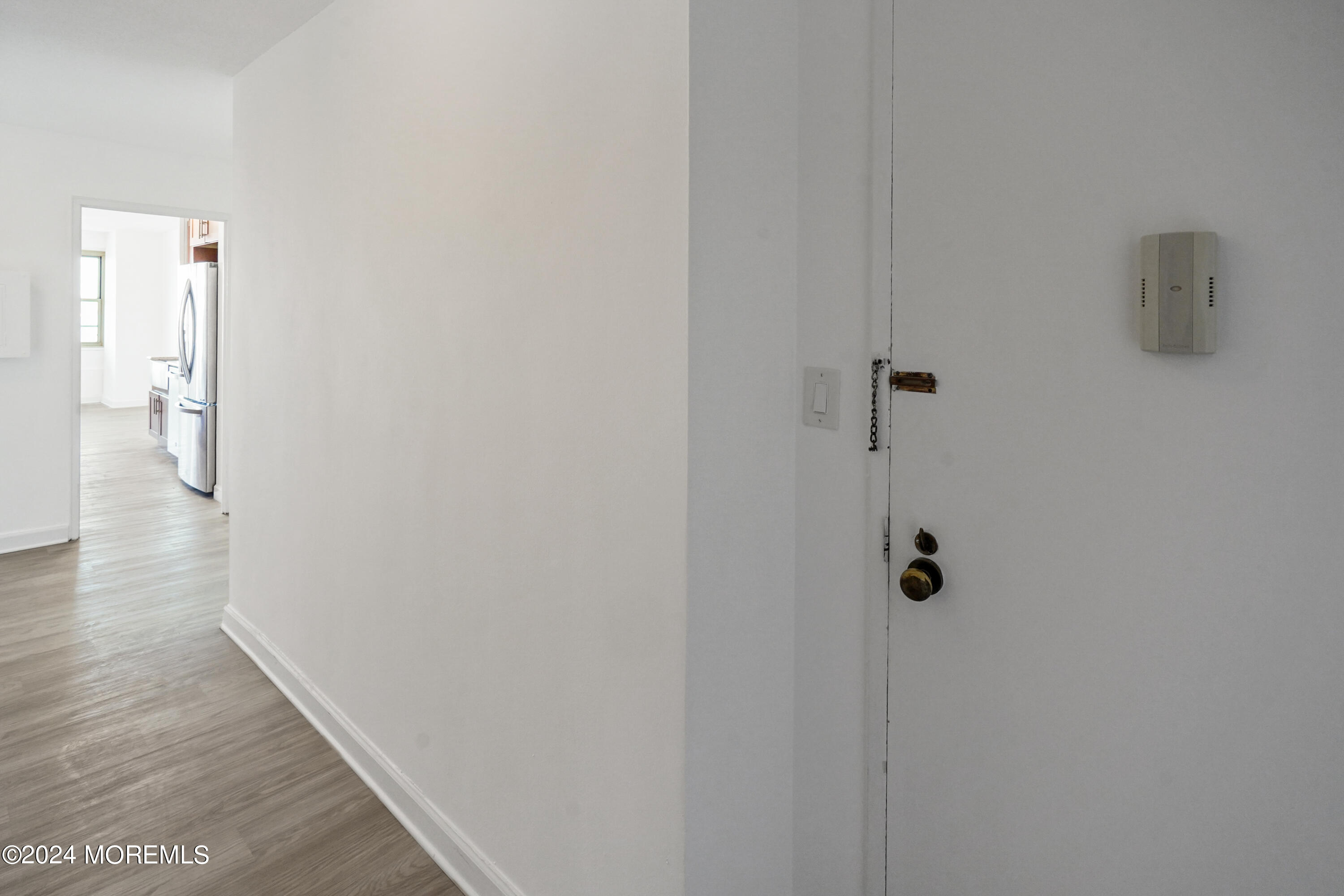 28 Riverside Avenue, Unit 8N Red Bank, NJ 07701 - Photo 21 of 30 a view of a hallway with wooden floor
