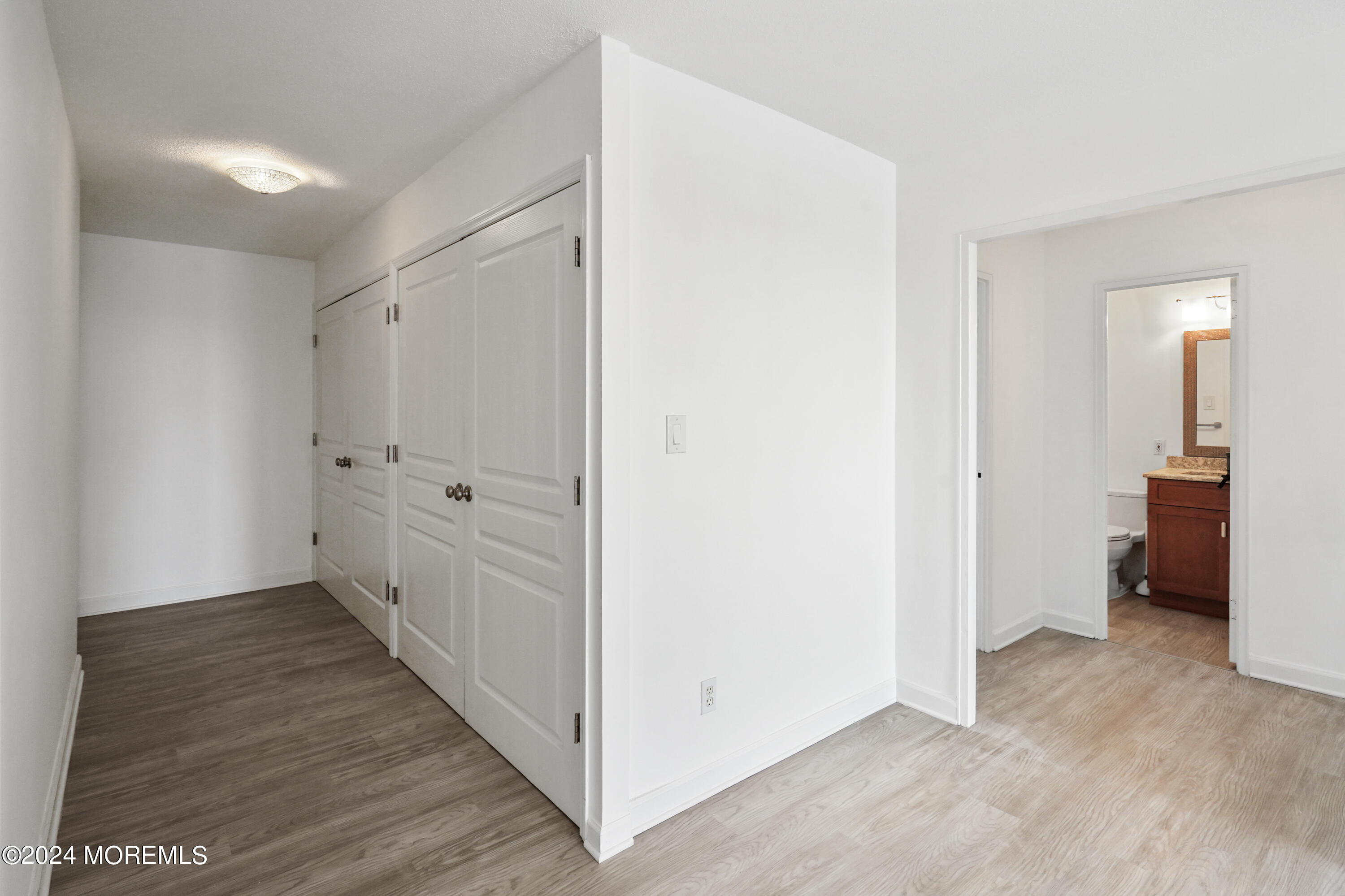 28 Riverside Avenue, Unit 8N Red Bank, NJ 07701 - Photo 22 of 30 a view of a hallway with wooden floor
