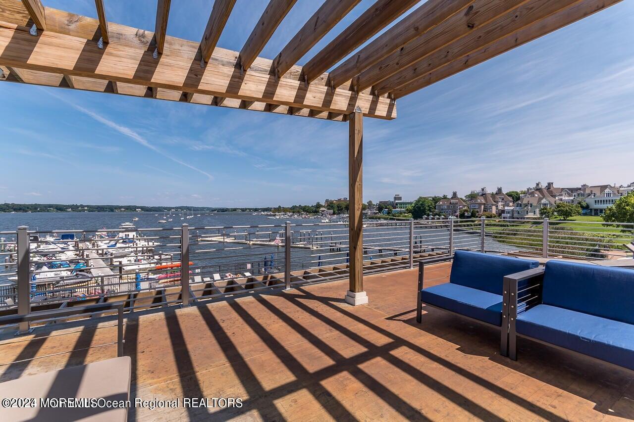 28 Riverside Avenue, Unit 8N Red Bank, NJ 07701 - Photo 26 of 30 a roof deck with a table and chairs