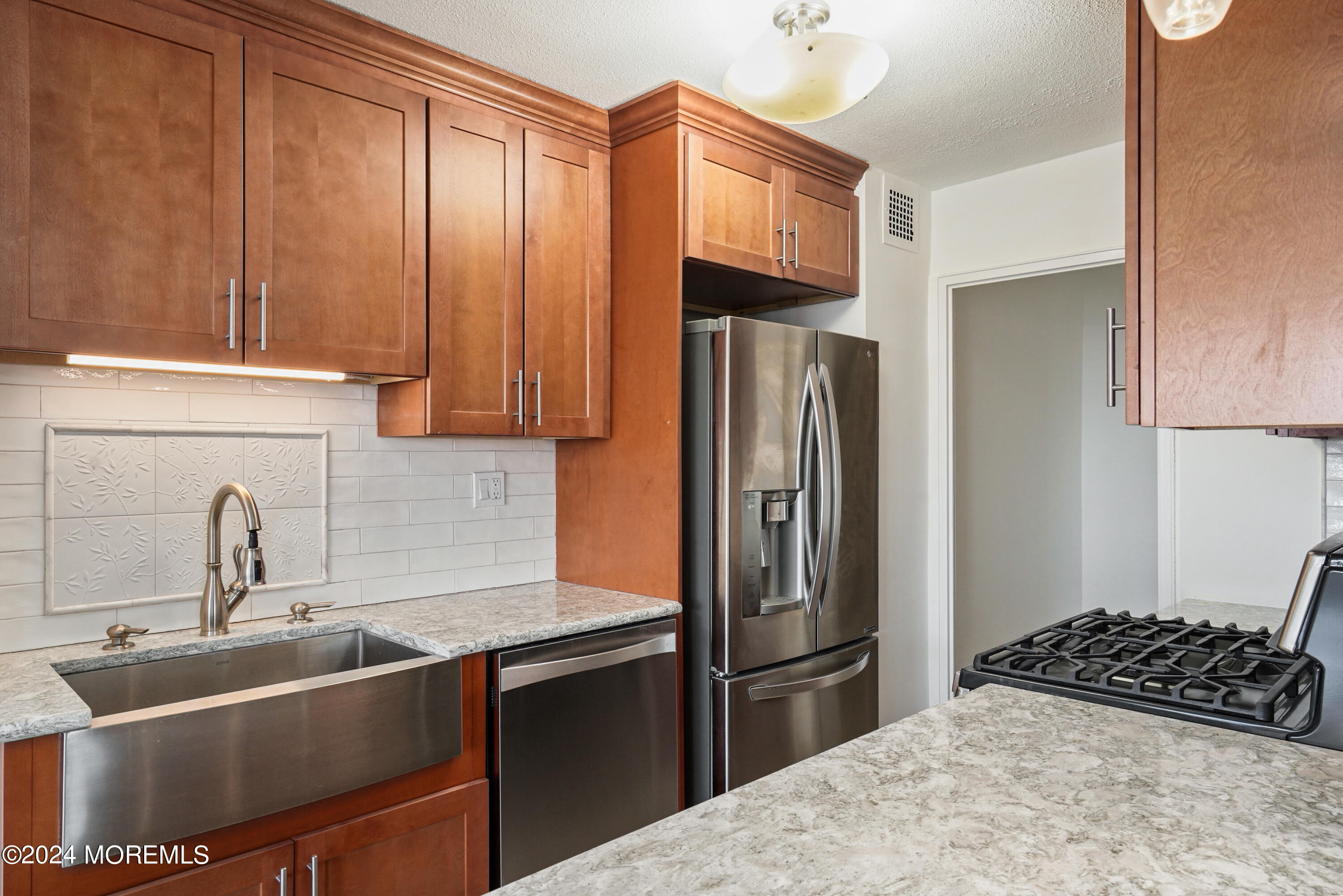 28 Riverside Avenue, Unit 8N Red Bank, NJ 07701 - Photo 3 of 30 a kitchen with stainless steel appliances granite countertop a refrigerator and a sink