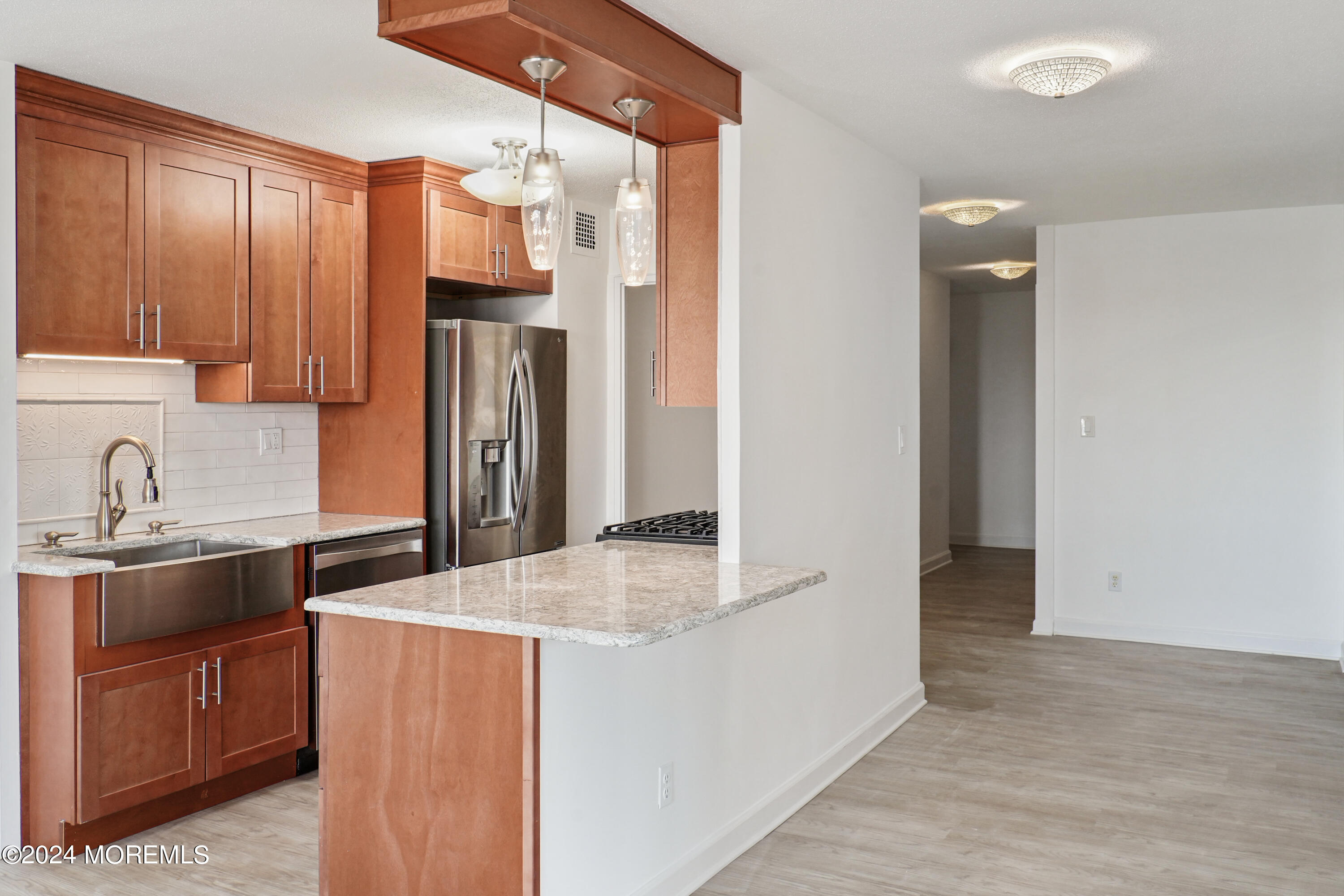 28 Riverside Avenue, Unit 8N Red Bank, NJ 07701 - Photo 5 of 30 a kitchen with stainless steel appliances granite countertop a sink and a stove