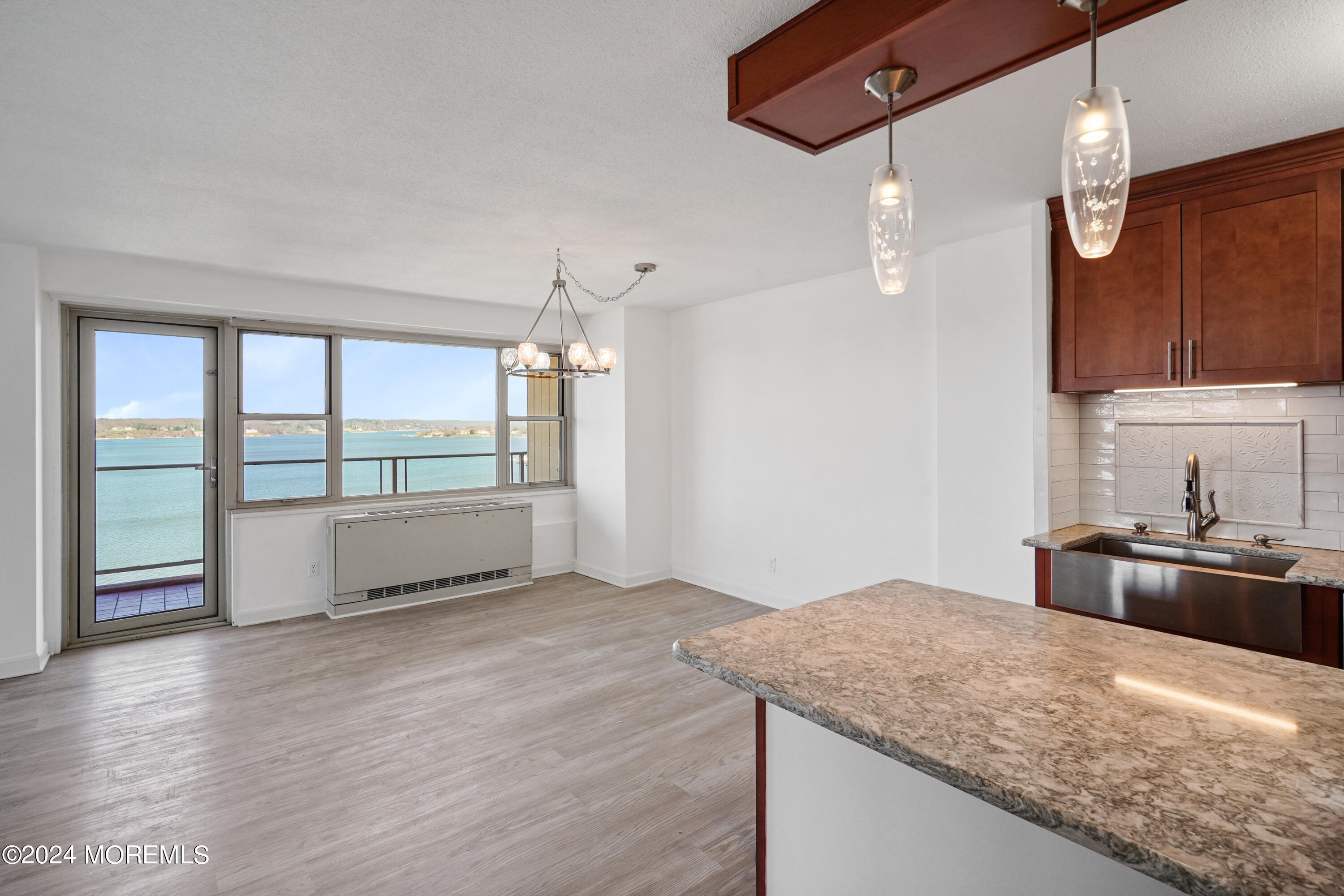 28 Riverside Avenue, Unit 8N Red Bank, NJ 07701 - Photo 6 of 30 a kitchen with stainless steel appliances granite countertop a sink dishwasher a stove and a refrigerator with wooden floor