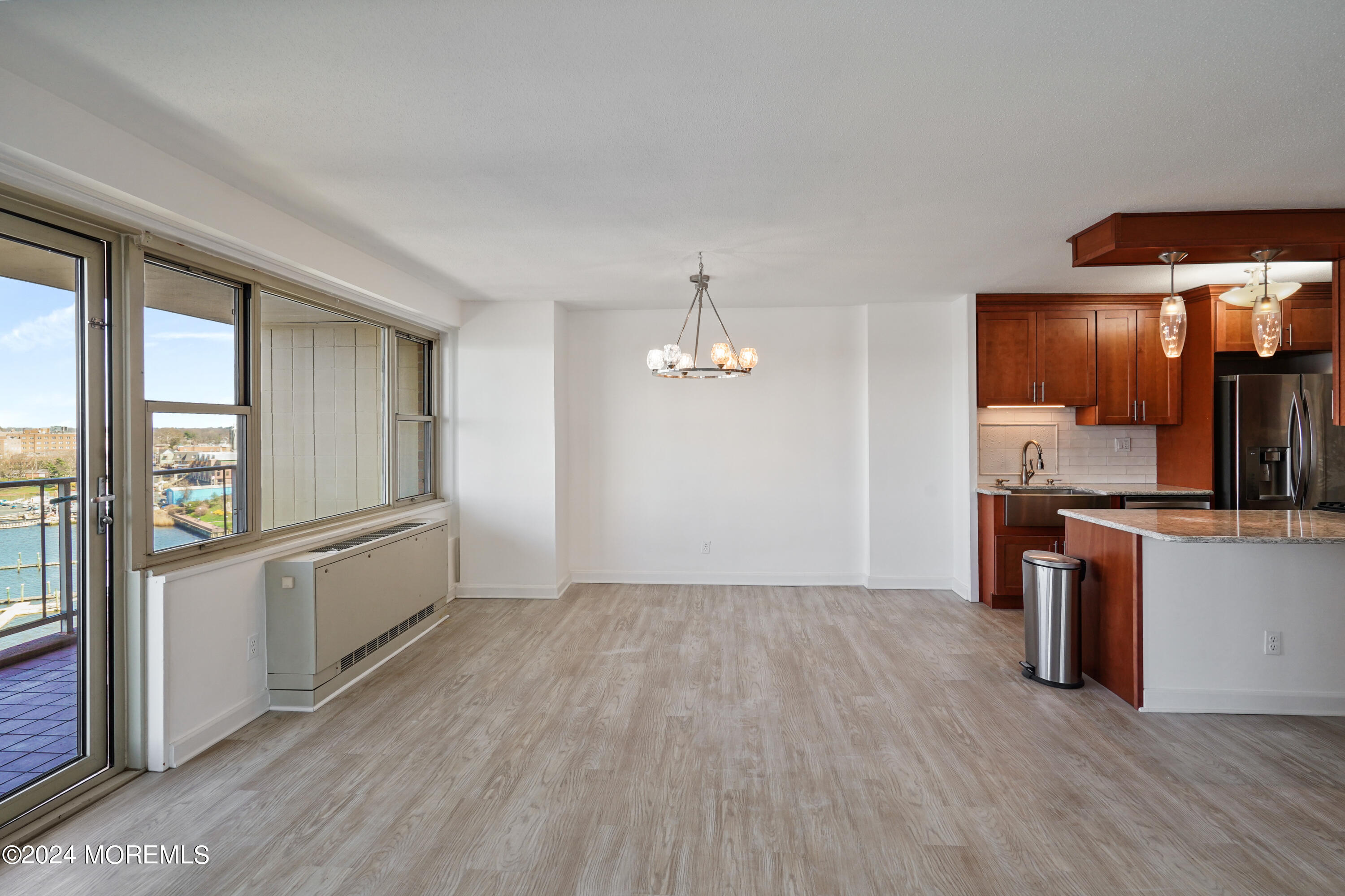 28 Riverside Avenue, Unit 8N Red Bank, NJ 07701 - Photo 7 of 30 a view of an empty room with window and wooden floor