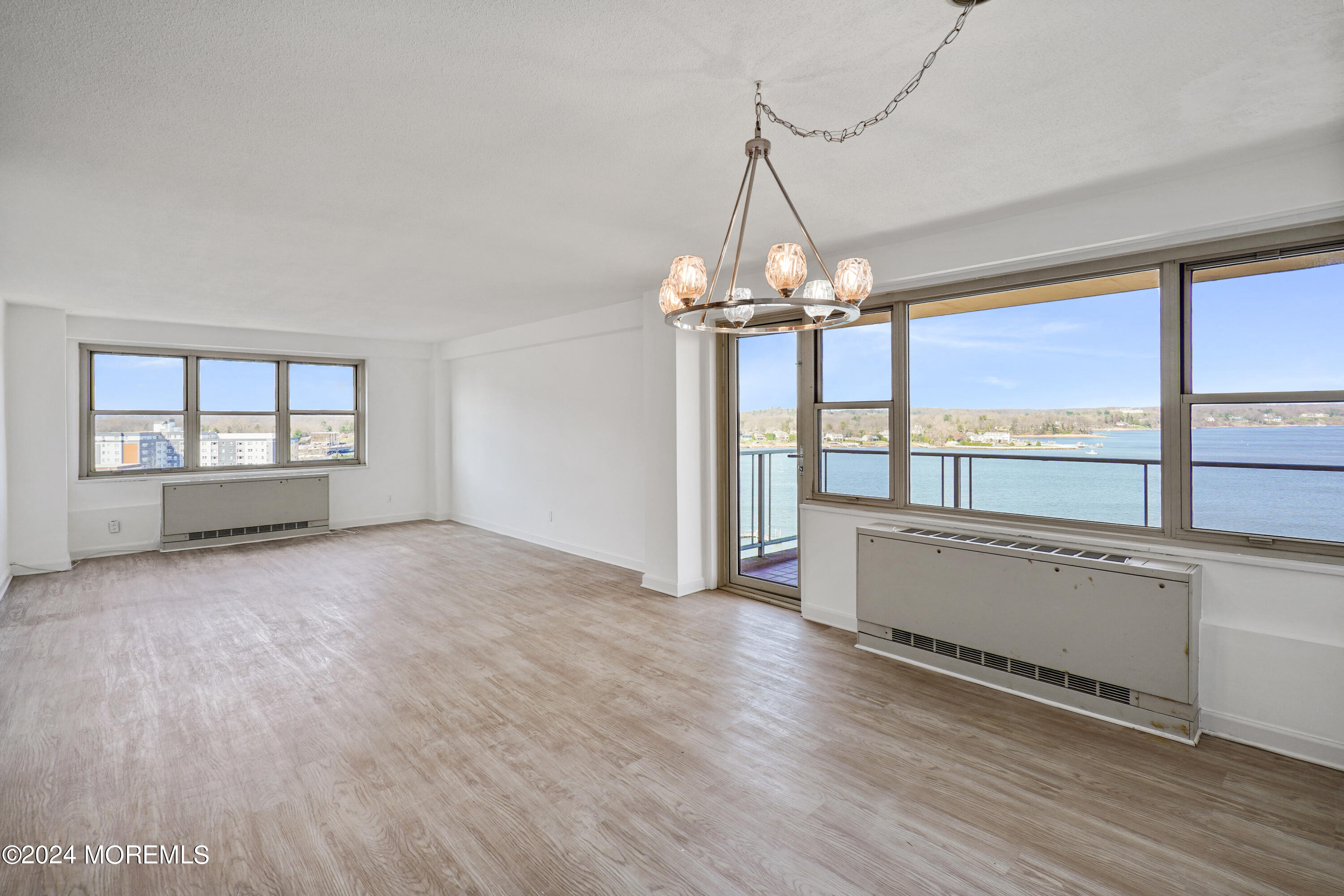 28 Riverside Avenue, Unit 8N Red Bank, NJ 07701 - Photo 8 of 30 an empty room with wooden floor and windows
