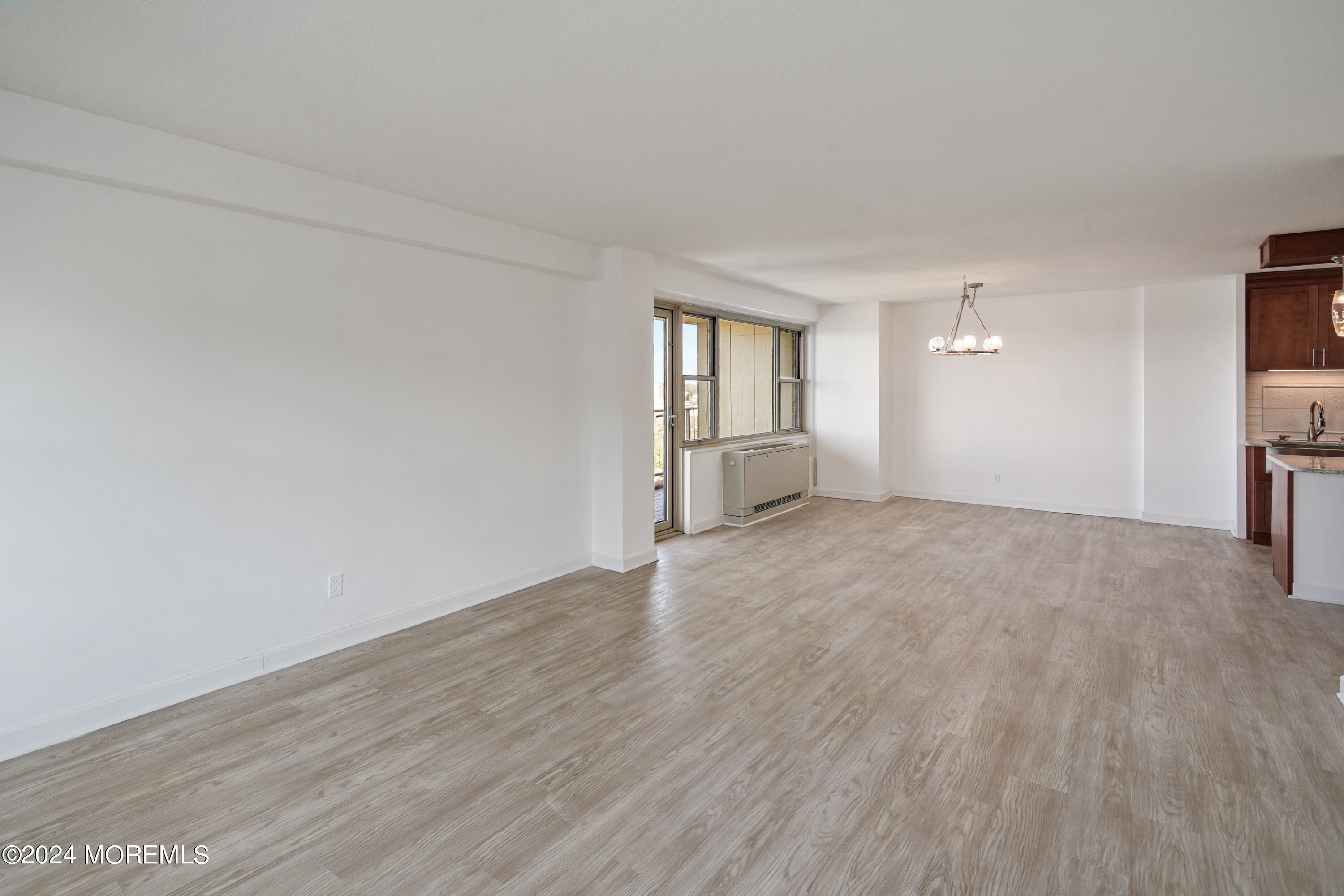 28 Riverside Avenue, Unit 8N Red Bank, NJ 07701 - Photo 10 of 30 a view of empty room with wooden floor