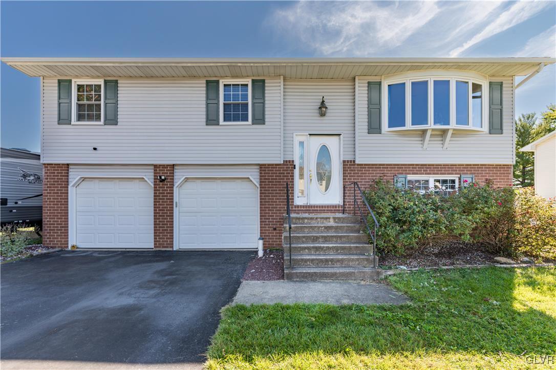 a front view of a house with a yard and garage
