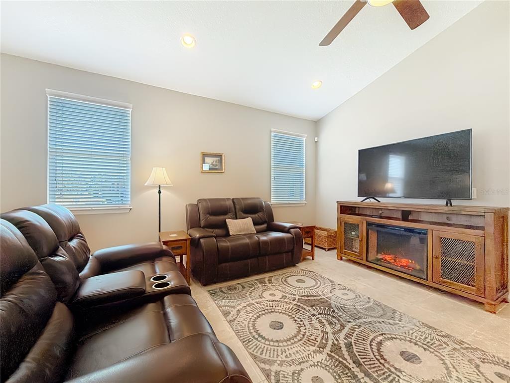 5647 Northwest 37th Lane Road Ocala, FL 34482 - Photo 11 of 50 a living room with furniture and a flat screen tv