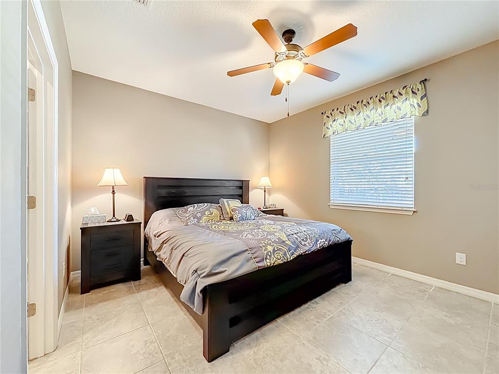 5647 Northwest 37th Lane Road Ocala, FL 34482 - Photo 14 of 50 a bedroom with a bed and window