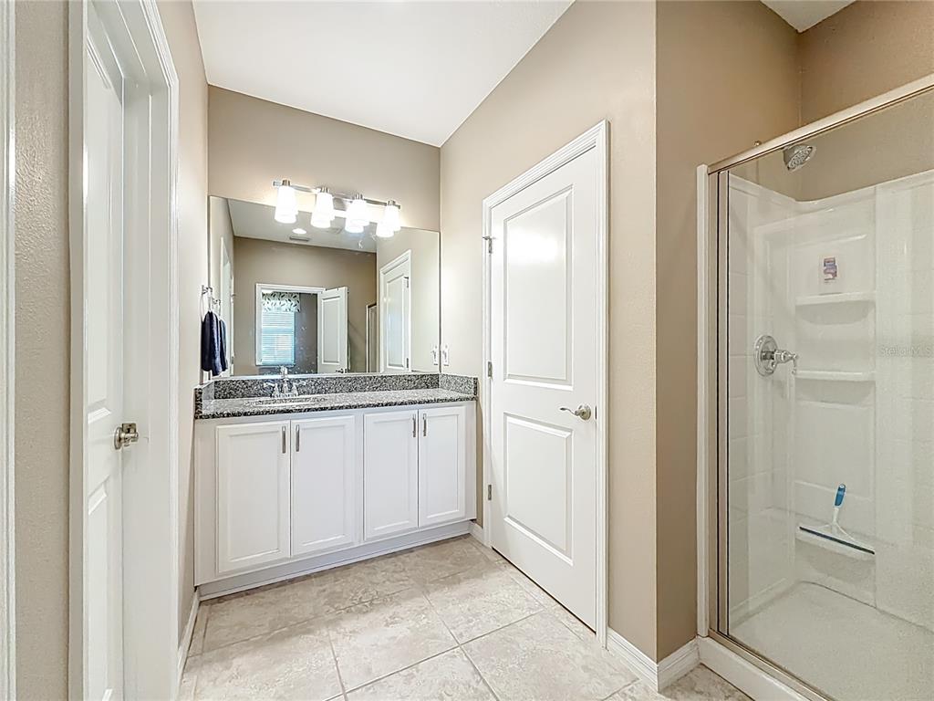 5647 Northwest 37th Lane Road Ocala, FL 34482 - Photo 15 of 50 a bathroom with a granite countertop sink mirror and a