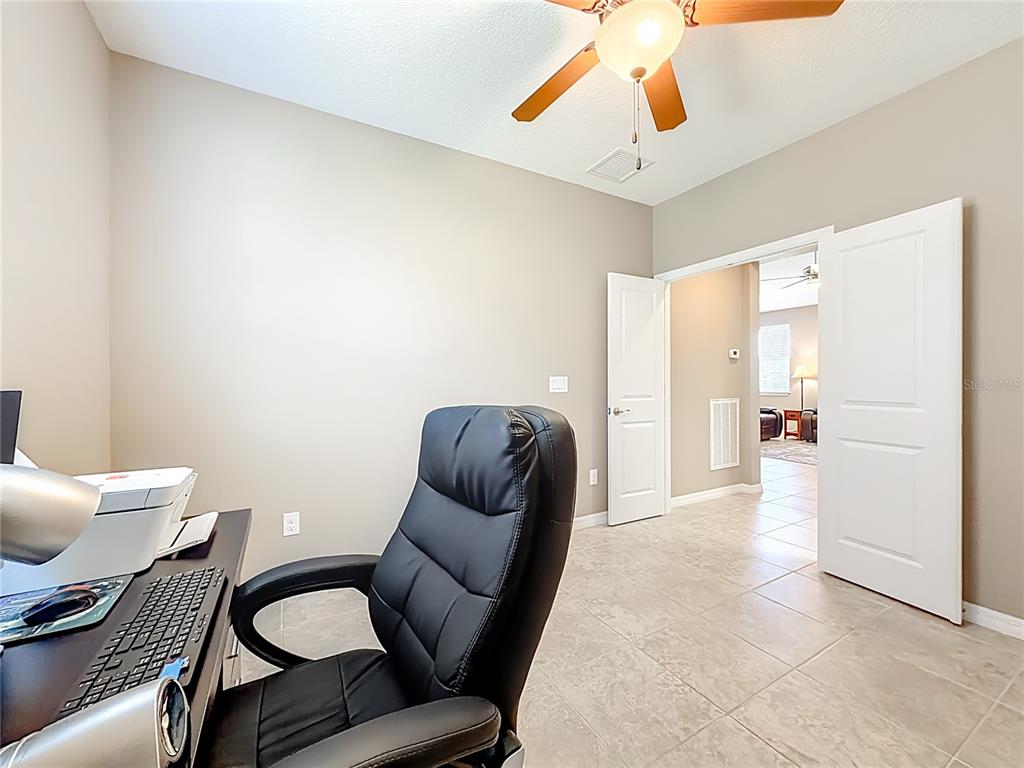 5647 Northwest 37th Lane Road Ocala, FL 34482 - Photo 20 of 50 a view of a hallway with furniture and a lamp