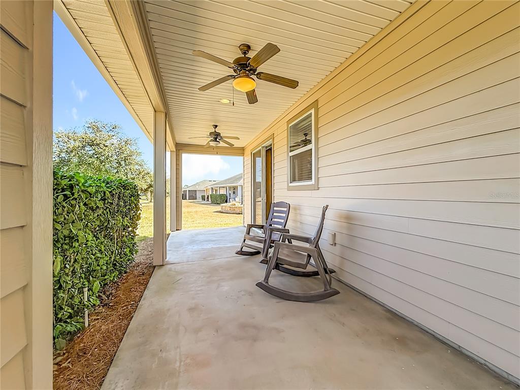 5647 Northwest 37th Lane Road Ocala, FL 34482 - Photo 22 of 50 a view of a patio with table and chairs and potted plants