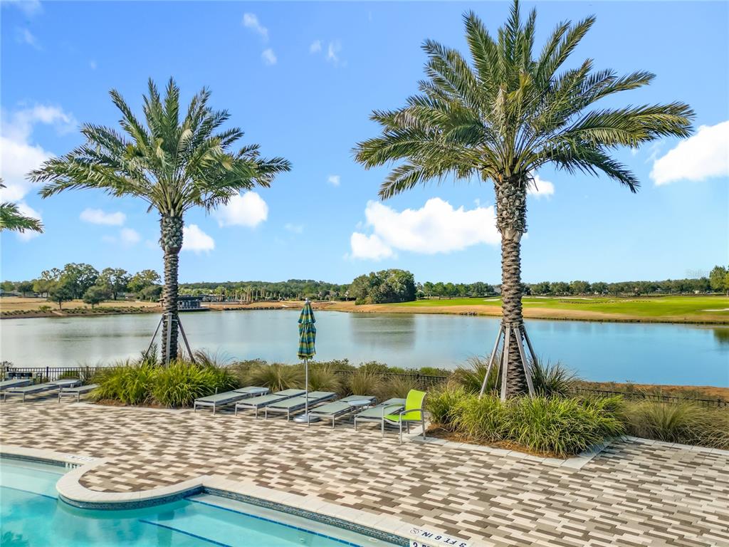 5647 Northwest 37th Lane Road Ocala, FL 34482 - Photo 37 of 50 a view of a lake with palm trees and swimming pool