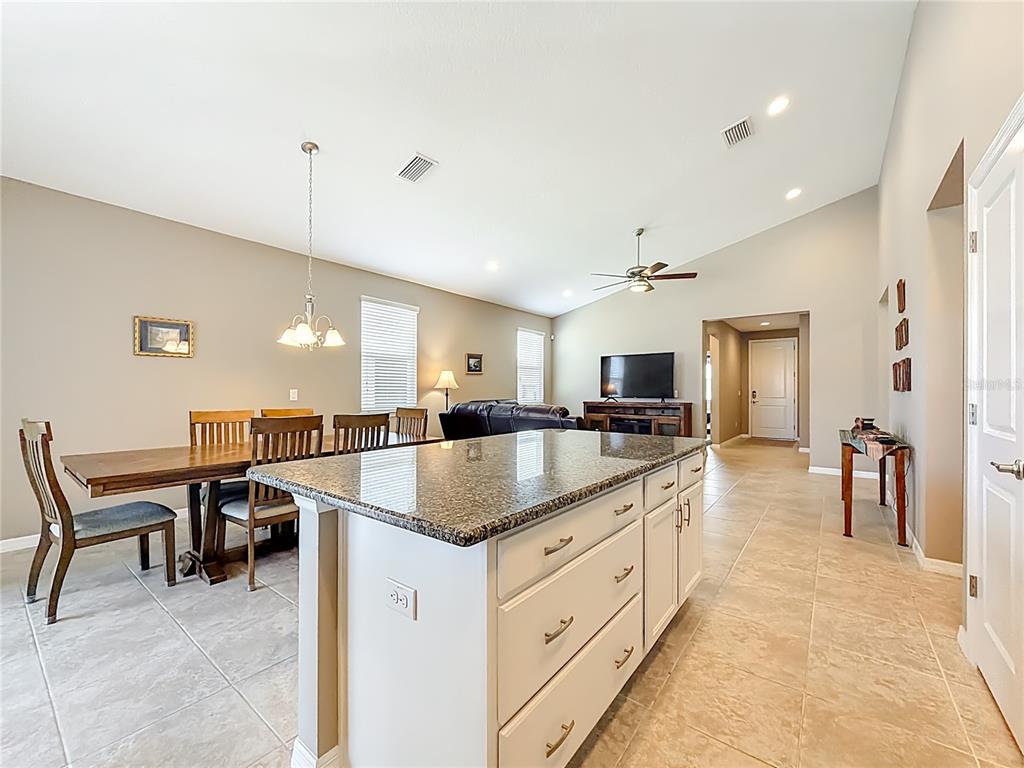 5647 Northwest 37th Lane Road Ocala, FL 34482 - Photo 6 of 50 a kitchen with center island table and chairs