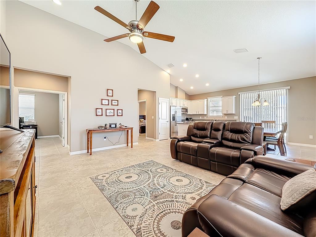 5647 Northwest 37th Lane Road Ocala, FL 34482 - Photo 9 of 50 a living room with furniture and a chandelier