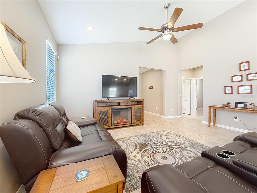 5647 Northwest 37th Lane Road Ocala, FL 34482 - Photo 10 of 50 a living room with furniture and a flat screen tv