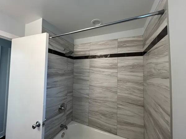 a bathroom with a glass shower door