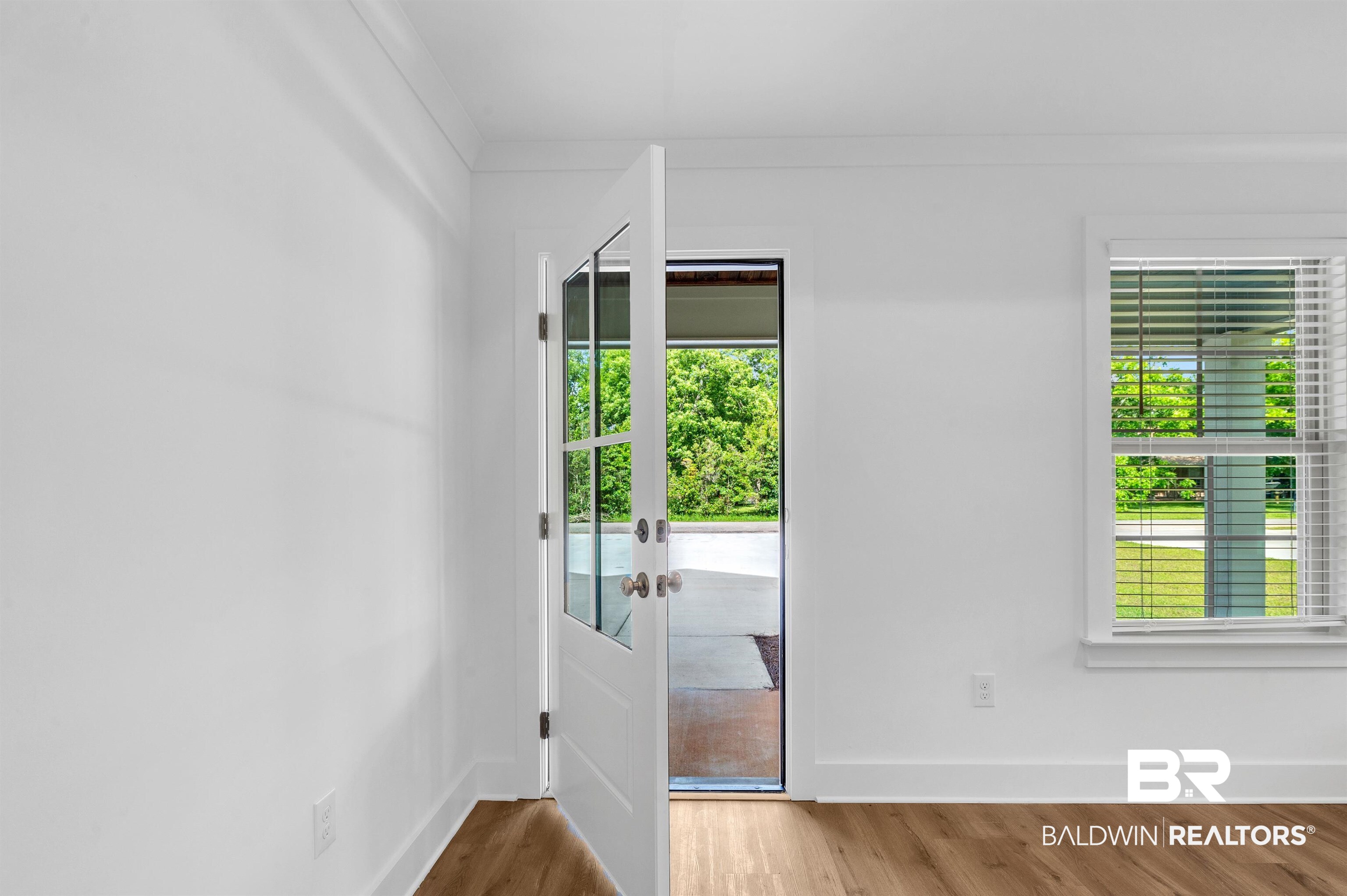 22045 8th Street Silverhill, AL 36576 - Photo 5 of 39 Entryway with wood finished floors, baseboards, and french doors