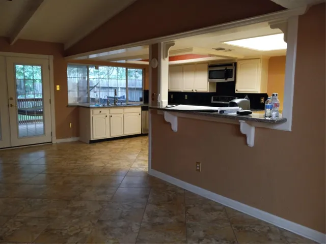 a view of a room with wooden floor
