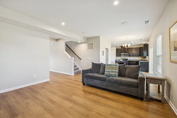a living room with furniture and kitchen view