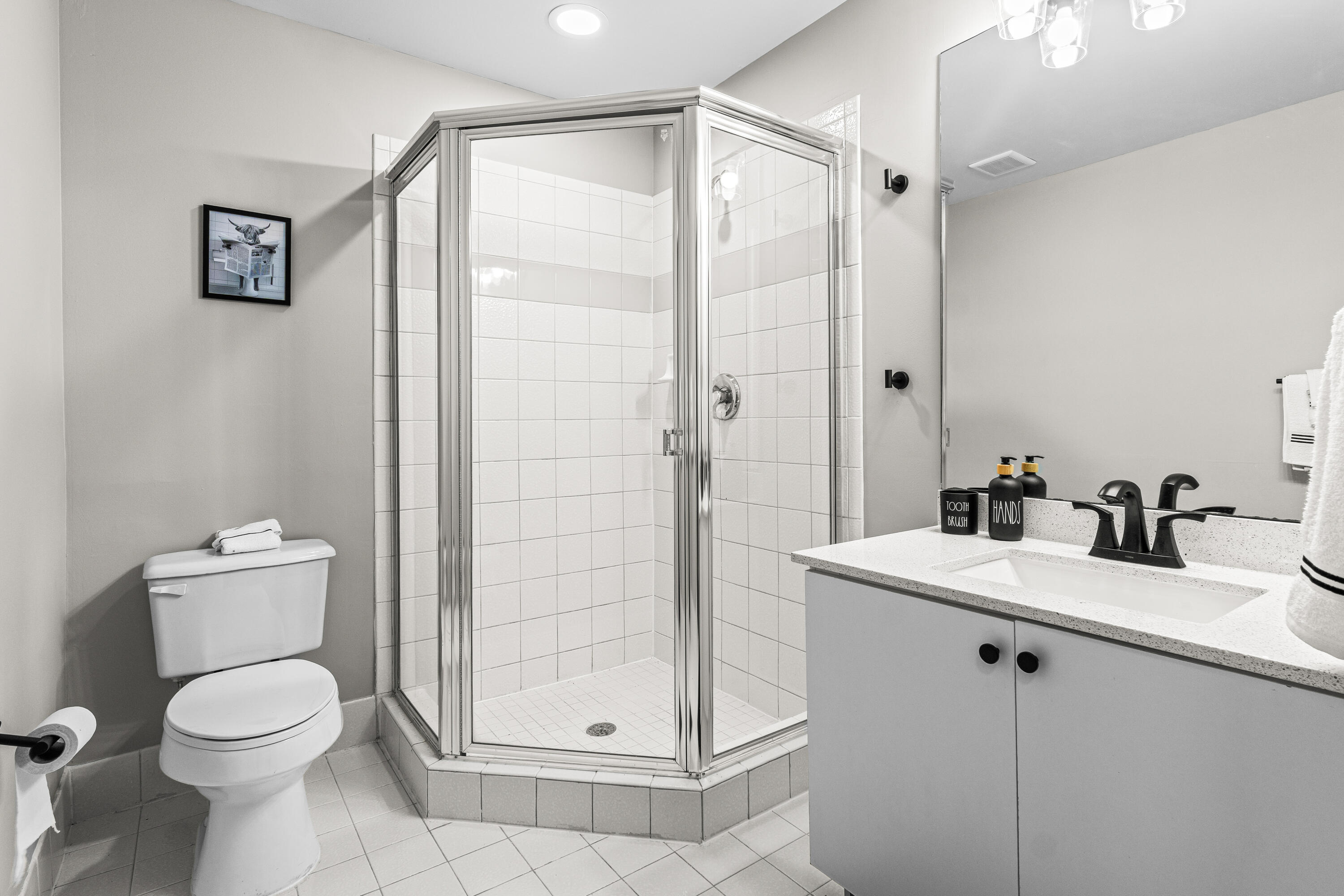 1959 Brandywine Road, Unit 208 West Palm Beach, FL 33409 - Photo 13 of 36 a bathroom with a toilet sink and shower