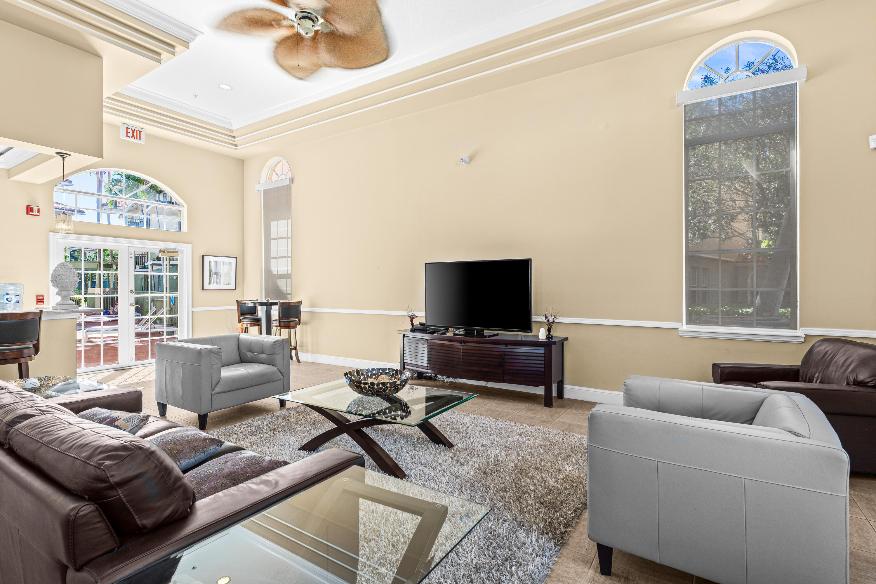 1959 Brandywine Road, Unit 208 West Palm Beach, FL 33409 - Photo 20 of 36 a living room with furniture and a flat screen tv