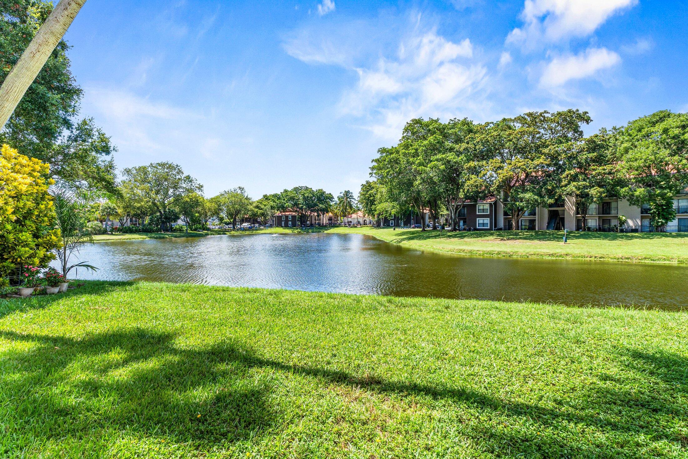 1959 Brandywine Road, Unit 208 West Palm Beach, FL 33409 - Photo 35 of 36 a view of a lake with a big yard
