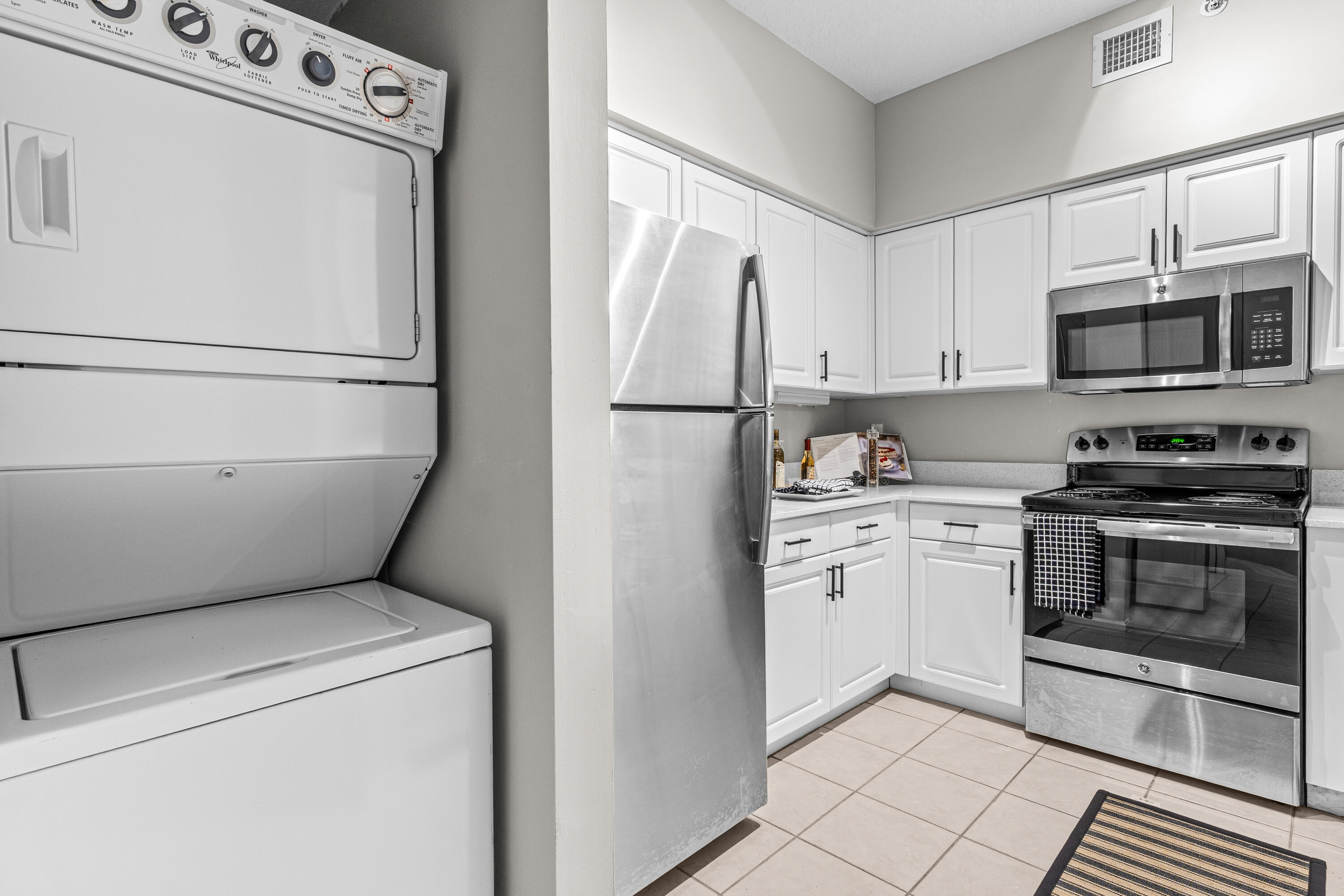 1959 Brandywine Road, Unit 208 West Palm Beach, FL 33409 - Photo 5 of 36 a kitchen with a refrigerator sink and stove