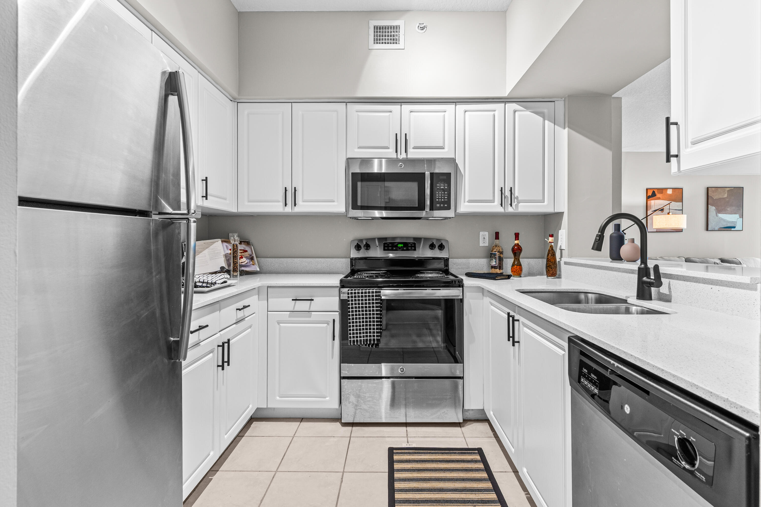 1959 Brandywine Road, Unit 208 West Palm Beach, FL 33409 - Photo 6 of 36 a kitchen with cabinets stainless steel appliances and a sink