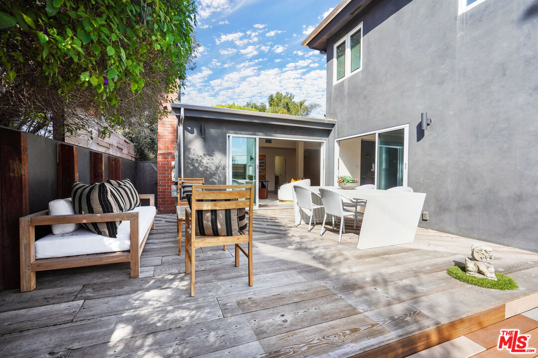 940 Rose Avenue Venice, CA 90291 - Photo 13 of 39 a view of a patio with dining table and chairs with wooden floor and fence